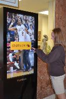 woman touching glass sign